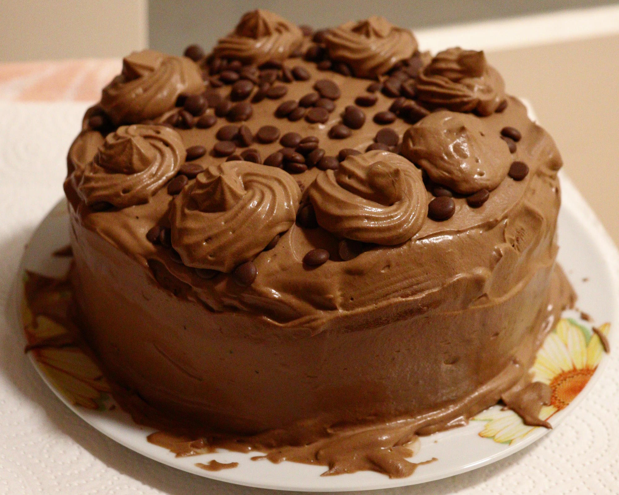 A chocolate cream cake sitting on a plate